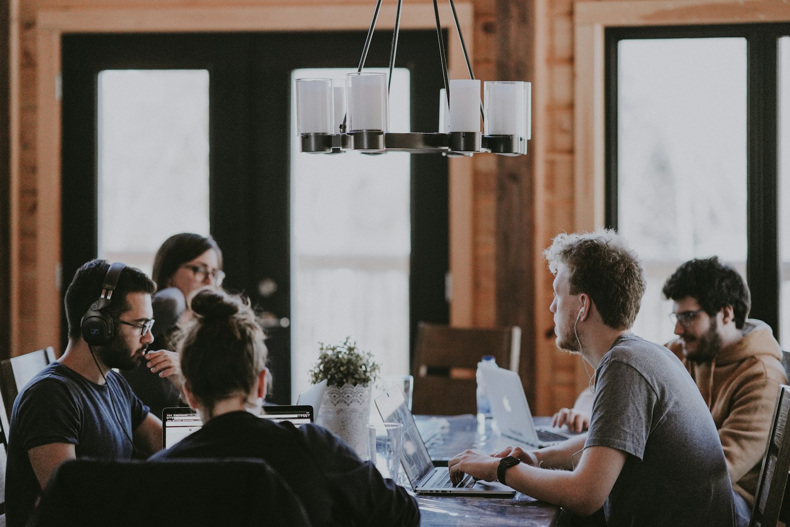 Team working together at a long table in a loft office